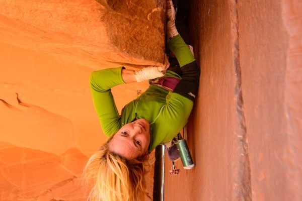 Pamela "Shanti" Pack working on the crux roof of the third pitch of hers and Partick Kingsbury's 3-pitch mega OW test piece in Indian Creek. "2nd amendment, Pistol Whipped Wall, Indian Creek Utah.